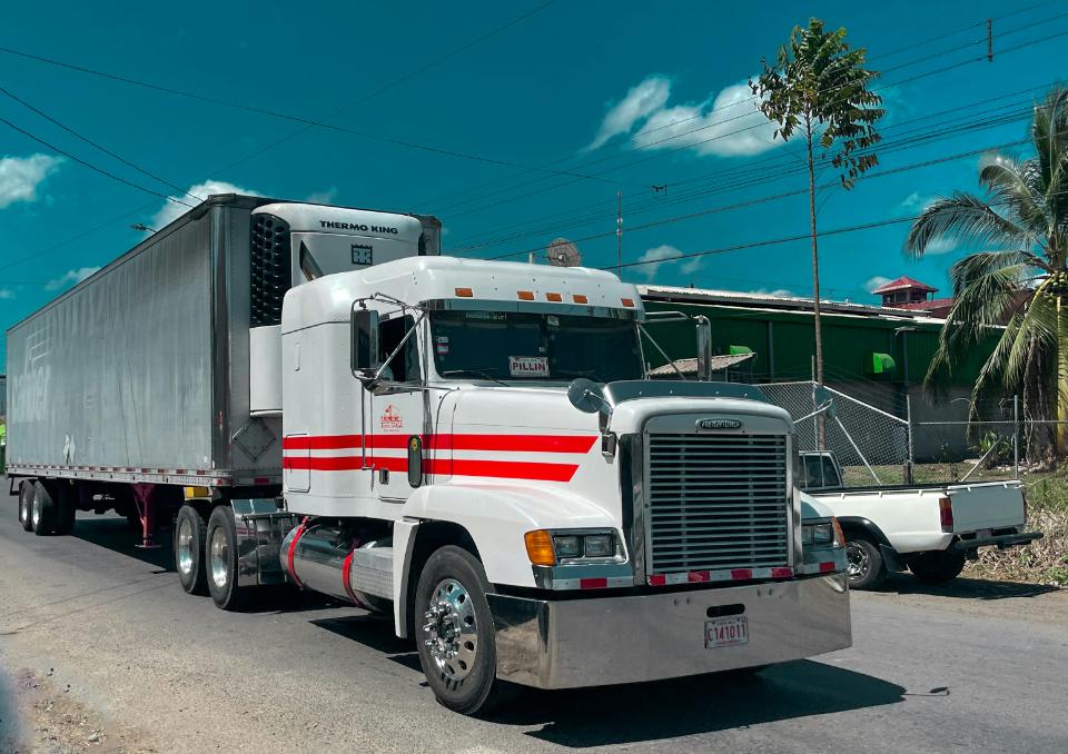 White semi-truck parked on a sunny street