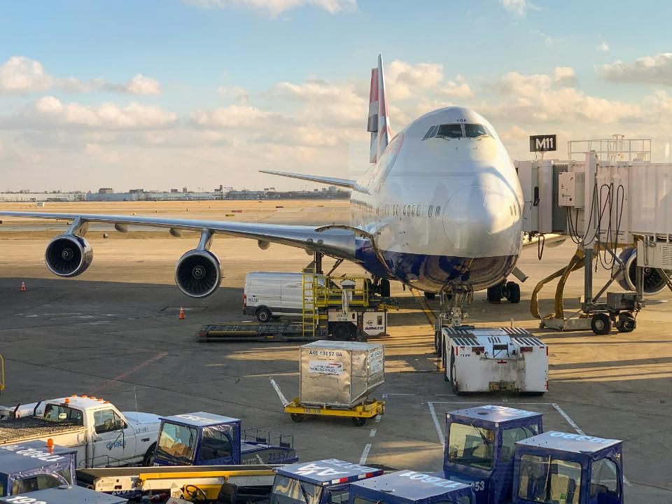 Large commercial airplane at airport loading gate.